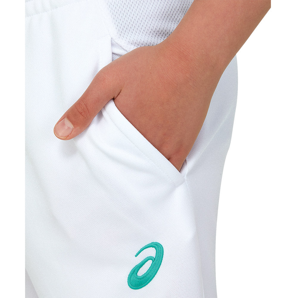 A hand in the left pocket of a pair of white ASICS cricket playing pants.