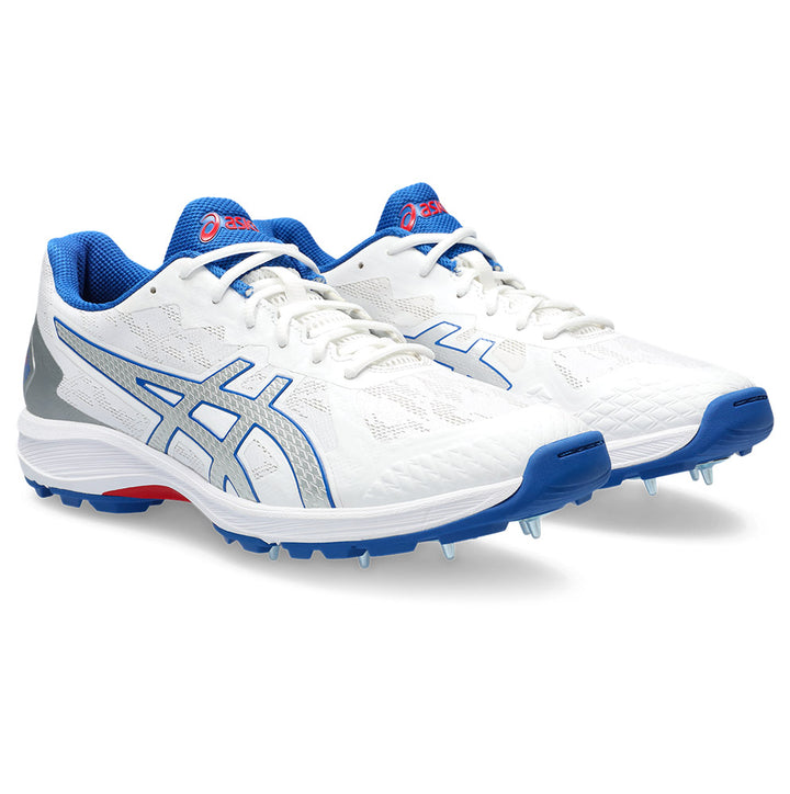 ASICS cricket shoe with white/silver color scheme and blue accents, featuring a spike configuration for traction and a running shoe hybrid design.