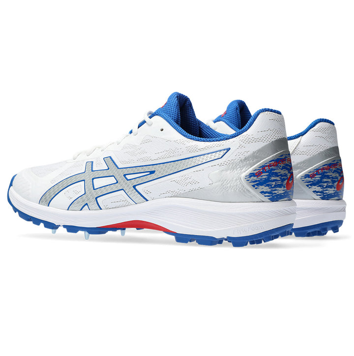 A rear-angled view of the ASICS Strike Rate cricket shoe with white/silver color scheme and blue accents.