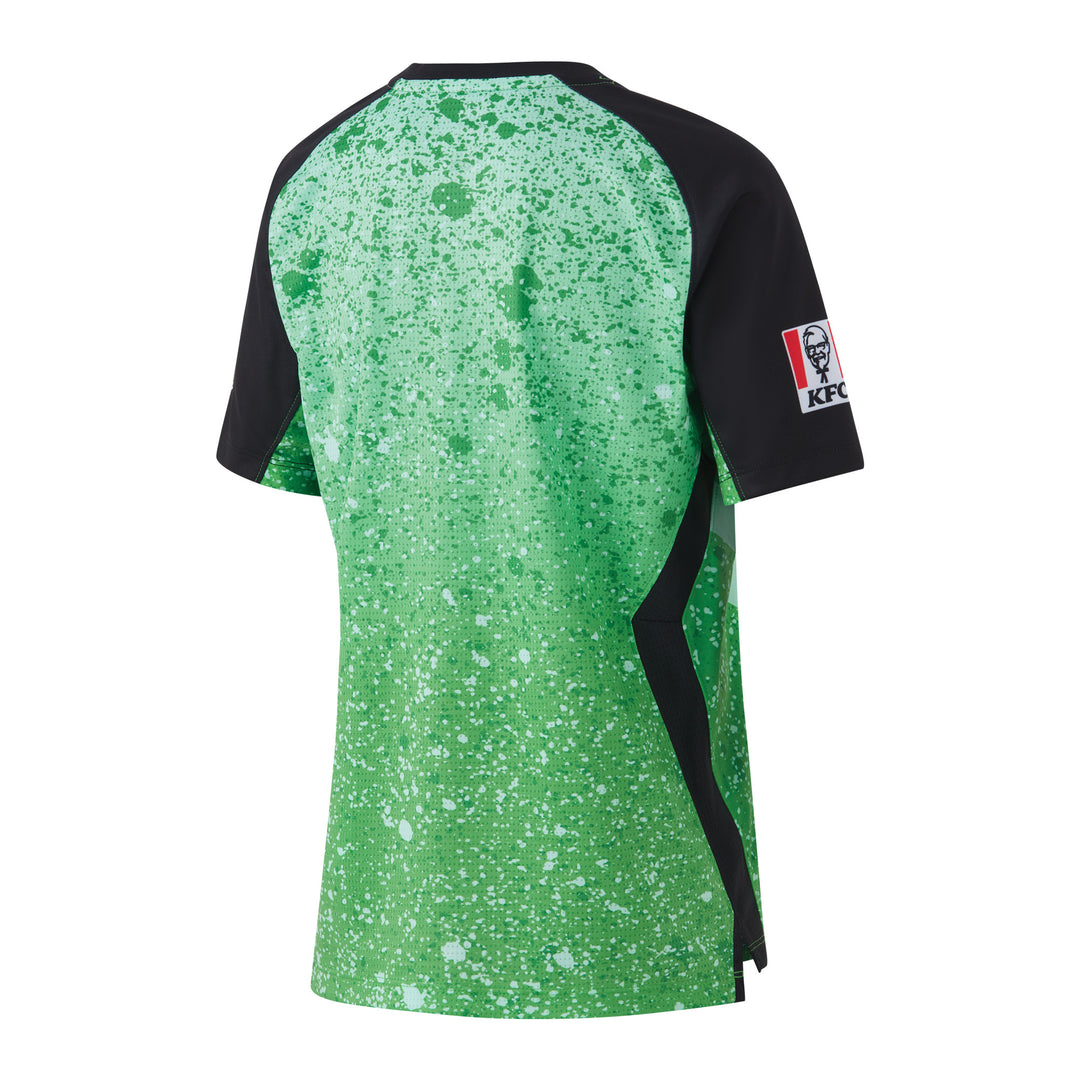 The back of a youth replica shirt with short sleeves featuring a green star pattern and the Melbourne Stars logo.