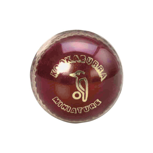 A mini leather cricket ball with the brand name 'KOOKABURRA' printed on it.
