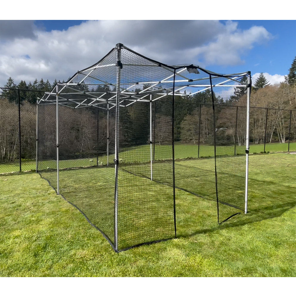 A folding cricket net with a steel frame and UV treated net, set up on a grass field.