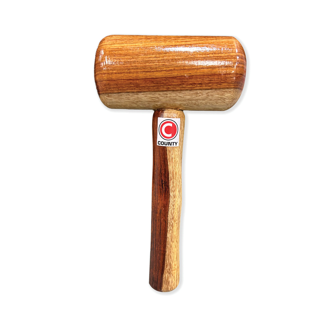 A wooden County brand bat mallet with a large cylindrical head and a long handle.