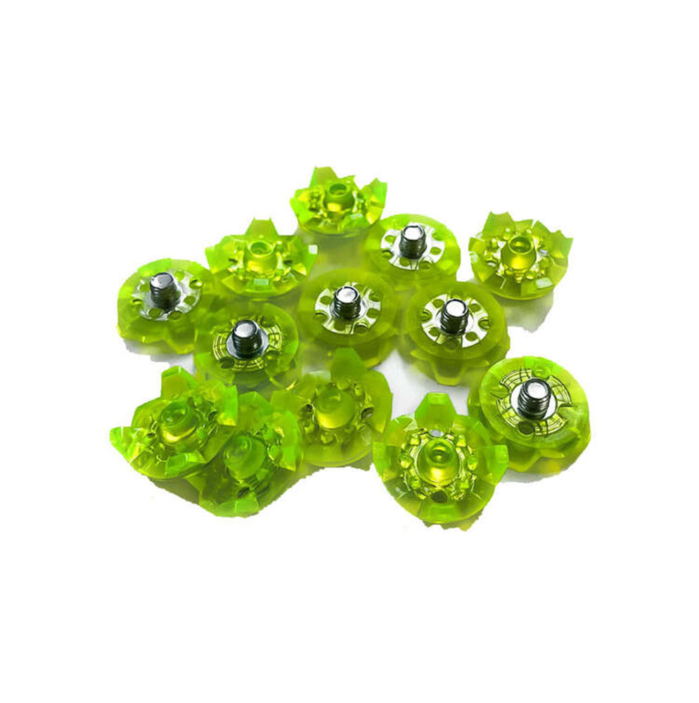A collection of green plastic spikes with silver accents, designed to be attached to cricket shoes for traction.