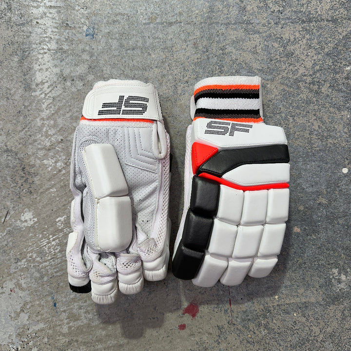 Pair of SF white sports gloves with black and red accents on a gray surface