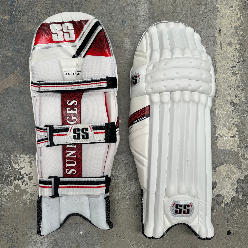 White SS cricket pads with red and black accents on a gray background