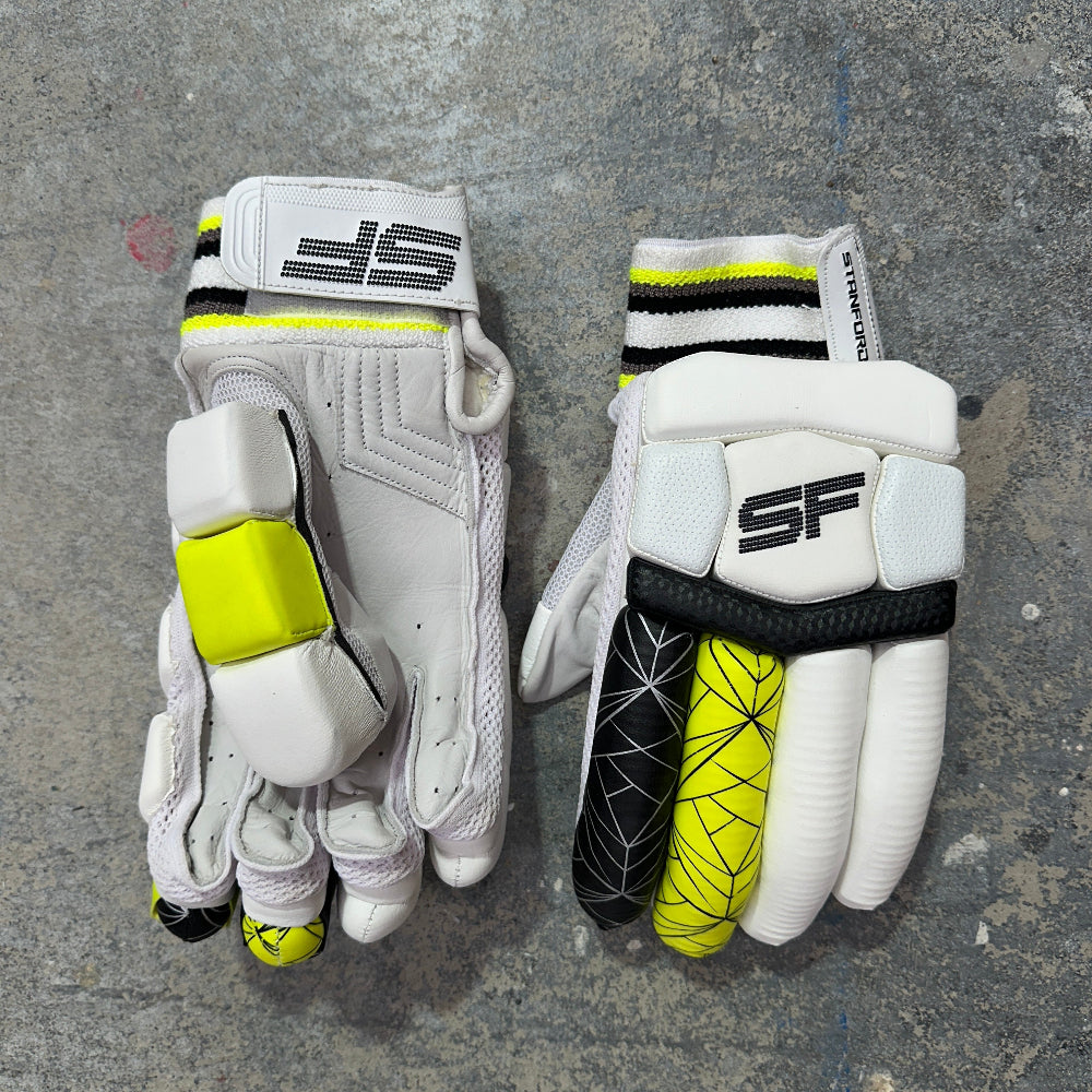Two white black and yellow  cricket gloves with SF branding.