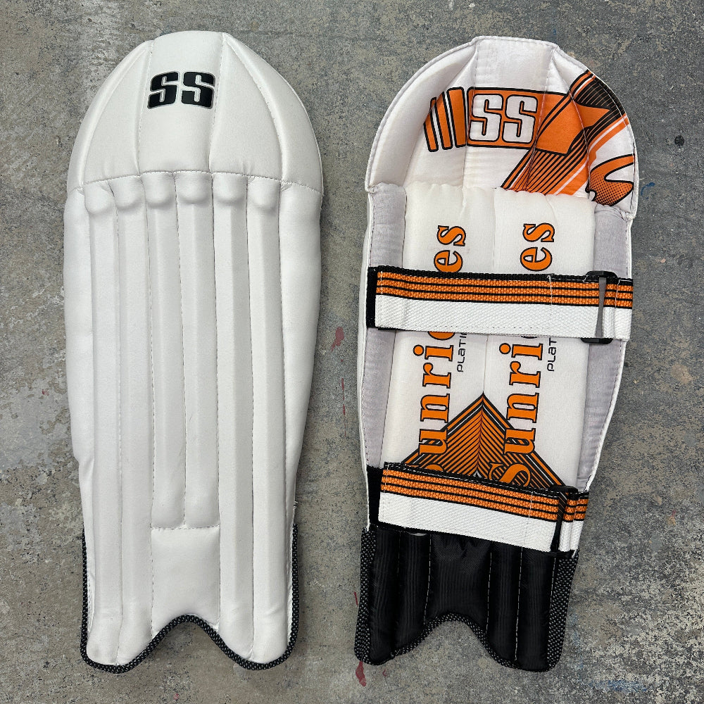 Two cricket pads with 'SS' and 'Sunridges' branding on a gray background