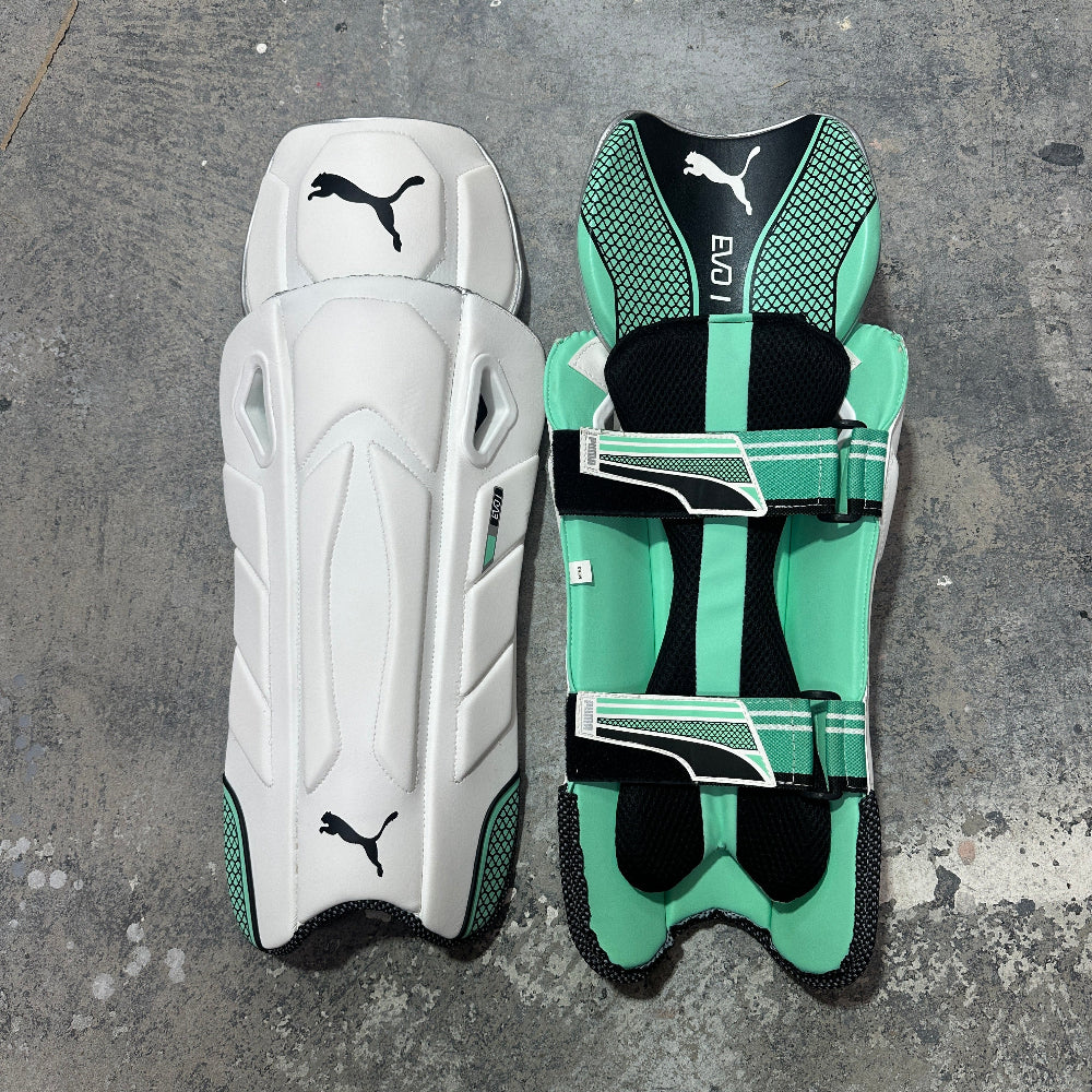 Pair of Puma shin guards on a gray surface