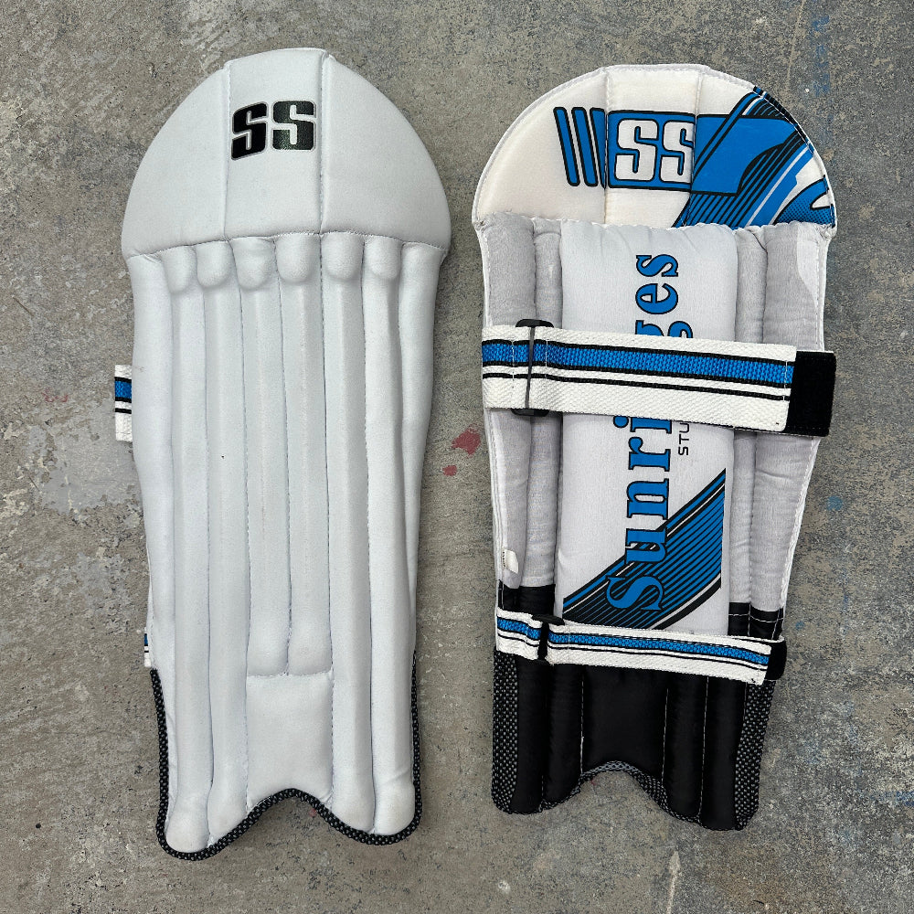 Pair of cricket keeping pads with 'SS' branding on a gray background