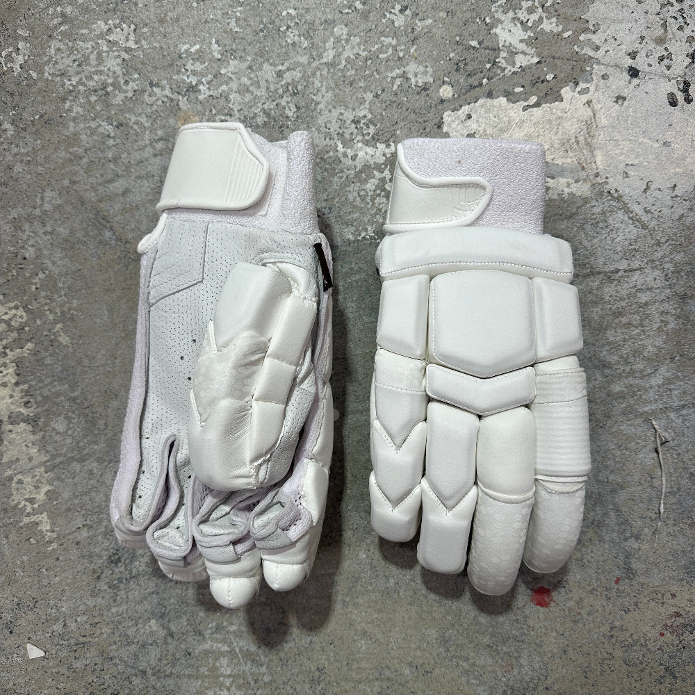 Pair of white batting gloves on a textured gray surface