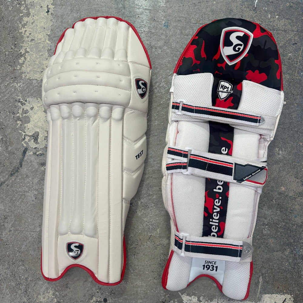 Pair of cricket pads with a SG brand logo on a textured surface