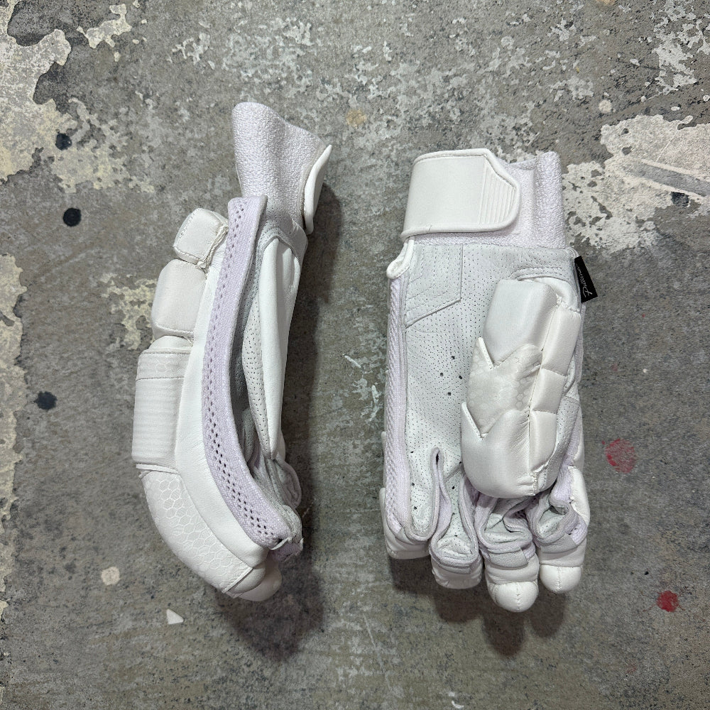Pair of white gloves on a textured gray surface