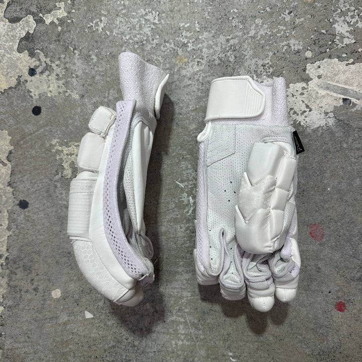 Pair of white gloves on a textured gray surface