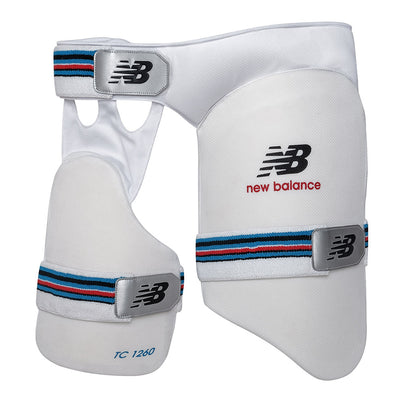 A pair of New Balance thigh pads with white as the primary color and blue and red accents, featuring adjustable waist straps and the New Balance logo.