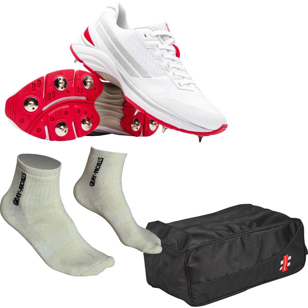A set of cricket spikes including a white and red shoe with metal spikes, a pair of light gray performance socks, and a black zippered storage bag with a GN logo. 